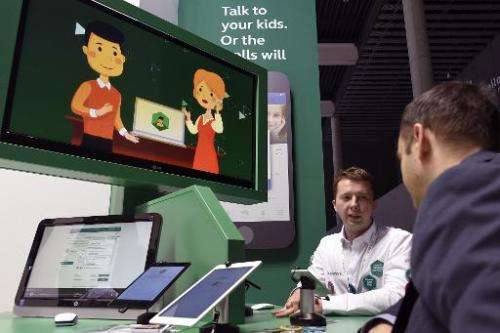 A technician explains how the Kaspersky antivirus aims to protect children during the 2015 Mobile World Congress in Barcelona on