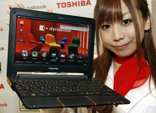 A Toshiba employee displays a Toshiba notebook PC at a Tokyo hotel