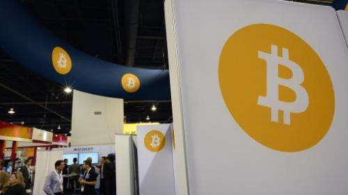 Attendees visit the Bitcoin stand, January 6, 2015 at the Consumer Electronics Show in Las Vegas, Nevada
