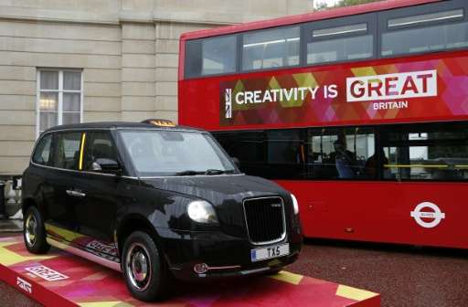 A TX5 London taxi (L) and a zero-emission red bus are pictured outside Lancaster House in central London, on October 21, 2015