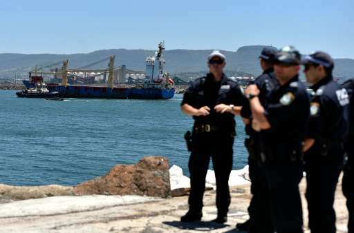 Australian police cordon the area as a ship transporting reprocessed nuclear waste arrives at Port Kembla in New South Wales on 