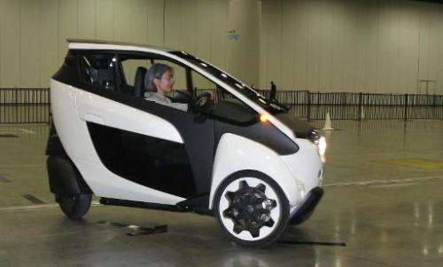 A visitor negotiates a course in a 3-wheel Toyota i-ROAD urban mobility prototype being demonstrated at the TED Conference in Va