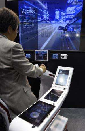 A visitor tests the In-Vehicle Service of Fujitsu during the 2015 Mobile World Congress in Barcelona on March 4, 2015