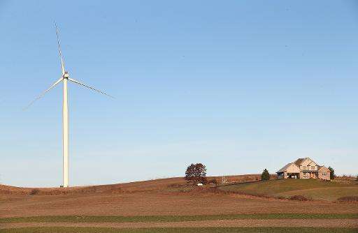 A wind turbine rises up above farmland near Middleton, Wisconsin on November 19, 2013
