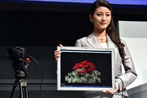 A woman displays Panasonic's new large tablet &quot;Toughpad 4K&quot; in Tokyo on June 23, 2015