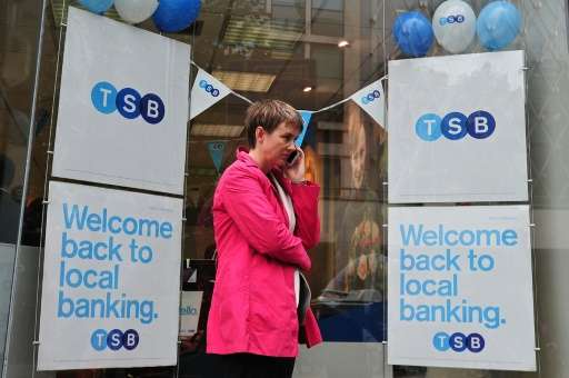 A woman talks on her phone outside a TSB bank branch in central London