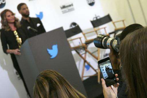A woman uses the Twitter Periscope app on her smartphone to live broadcast a press conference in Santa Monica, California, April