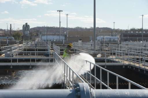 A worker is seen cleaning a wastewater pool at DC Water's Blue Plains plant in Washington, DC