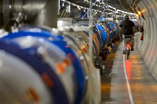 A worker rides his bicycle in a tunnel alongside the European Organisation for Nuclear Research (CERN) Large Hadron Collider (LH