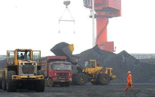 A worker walks at a coal terminal at Lianyungang port in Lianyungang, China, on June 23, 2014