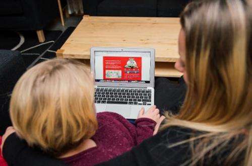 A young girl and her mother read information on a hospital website in Sweden, where web-savvy children who face hospital stays a