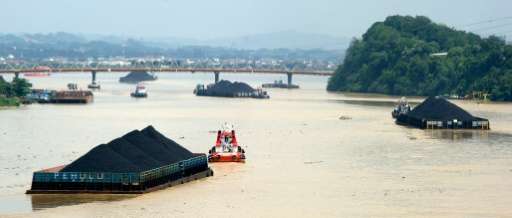 Barges carrying masses of coal float down the in Samarinda in Indonesia, one of the world's biggest exporters of coal