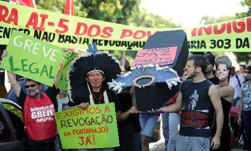 Brazilian natives and employees of the National Indian Foundation protest against the government's decision to authorize actions