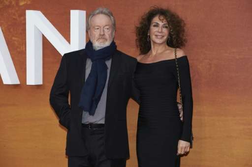 British filmmaker Ridley Scott (L) and his partner Costa Rican actress Giannina Facio pose for photographers as they arrive for 