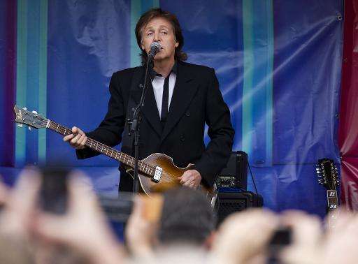 British musician Paul McCartney performs during an impromptu gig in Covent Garden in London on October 18, 2013