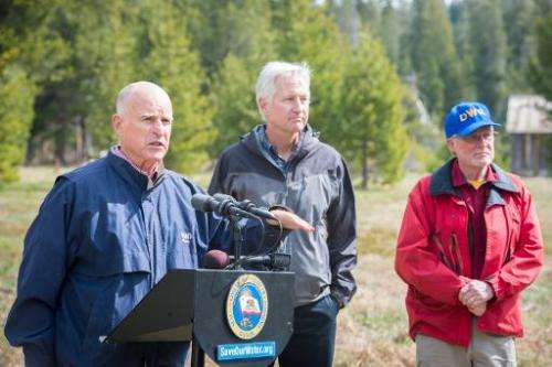 California Governor Jerry Brown (L) addresses a press conference with California Department of Water Resources workers in Philli