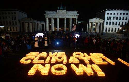 Candles in paper bags are placed to form the lettering &quot;Save our climate, Now&quot; in Berlin during the global climate cha