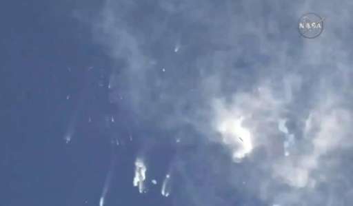 Debris from the SpaceX Falcon 9 rocket is seen falling from the sky after it exploded shortly after launch from Cape Canaveral, 