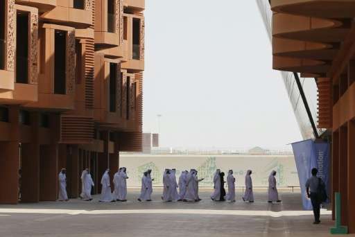 Emiratis walk in Masdar City, on the outskirts of the rich Emirate of Abu Dhabi, on October 7, 2015