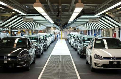 Employees of German car maker Volkswagen check cars at a assembly line of the VW plant in Wolfsburg, central Germany, on October