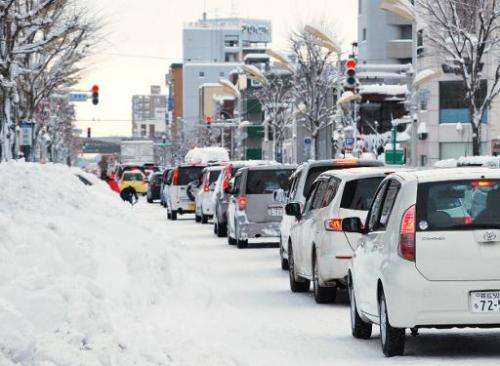 Energy saving traffic lights in Japan are failing to melt snow covering them