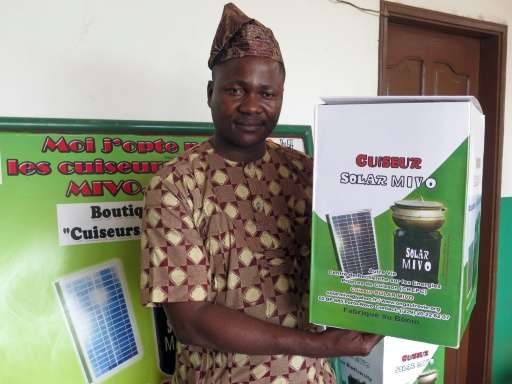 Executive director of the charity Autre Vie (Another Life) Romuald Djivoessoun poses with a solar-powered cooker in Porto-Novo