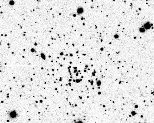 Far from home: Wayward cluster is both tiny and distant