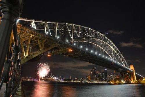 Fireworks go off at the Sydney Harbour Bridge and Opera House to signal the start of Earth Hour