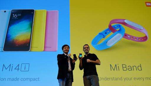Founder, Chairman and CEO of  Xiaomi Global, Lei Jin (L) and Vice President, Hugo Barra gesture during the launch of Xiaomi's Mi