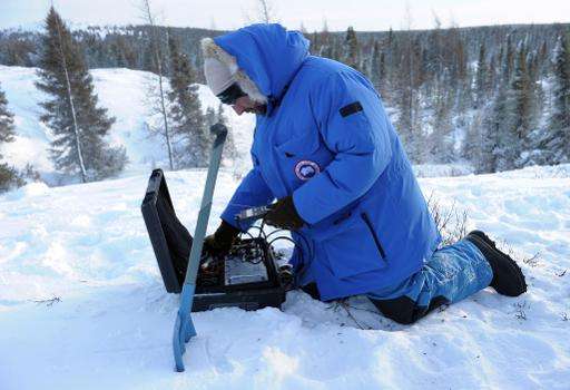 French biologist and leading scientist at Takuvik Joint International Laboratory sets up equipment to detect temperature changes