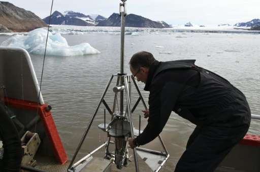 French oceanographer Philippe Kerherve takes samples from the Kongsfjorden fjord near the scientific base of Ny-Alesund on July 
