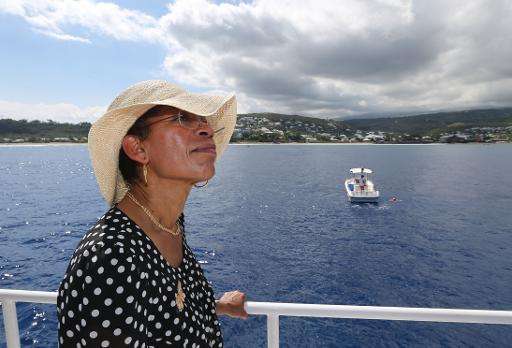 French Overseas Territories minister George Pau-Langevin is pictured on a boat on April 24, 2014 off les Roches Noires beach, on