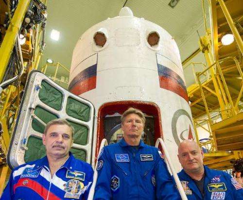 (From left) Russian cosmonauts Mikhail Kornienko and Gennady Padalka and US astronaut Scott Kelly pose in front of the Soyuz TMA