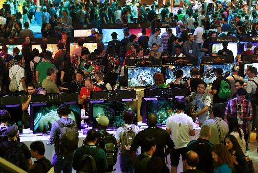 Gamers test new video games on display at the Sony Playstation area, on the opening day of the Electronic Entertainment Expo, kn