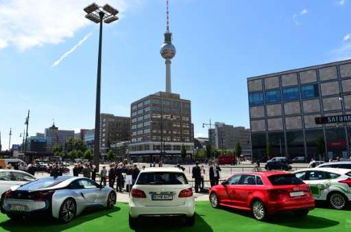 German-made electric cars are displayed in front of the Berlin Congress Centre during a two-day national conference on &quot;Ele