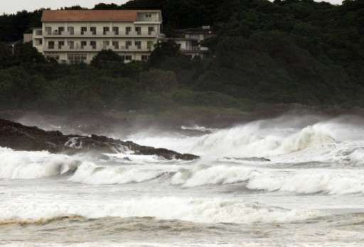 High waves crash into the coast at Hyuga in Miyazaki prefecture, Japan's southern island of Kyushu on July 16, 2015 after typhoo