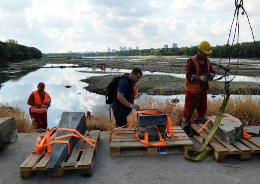 Historians recover 17th century relics from the Vistula river in Warsaw on September 3, 2015, after drought lowered the level of