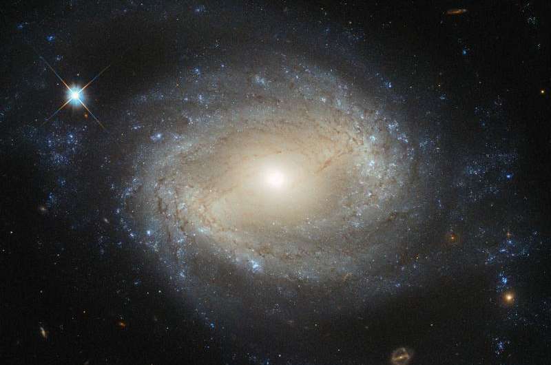 Hubble sees elegant spiral hiding a hungry monster