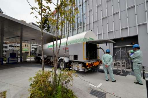 Hydrogen is being transfered from a tanker into a large gas tank, at a station of Japan's gas distributor Iwatani, in Tokyo