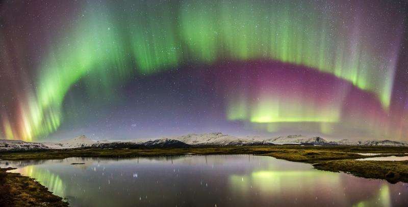 Image: Auroral curtain reflected in a placid Icelandic lake
