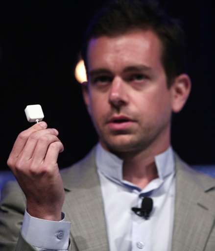 Jack Dorsey, CEO of Square, holds up a credit card reader on September 12, 2012 in Detroit, Michigan