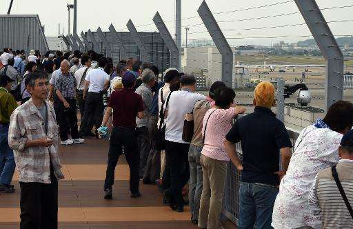 Japanese residents gather on an observation deck to watch the Solar Impulse 2 after it landed at Nagoya airport on June 2, 2015
