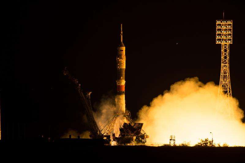 Launch, docking returns International Space Station crew to full strength