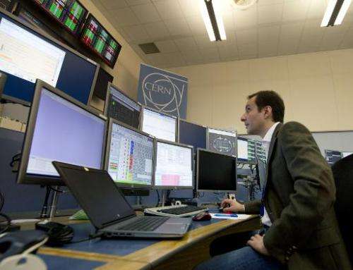 LHC operator Mirko Pojer watches screens at the CERN Control Center (CCC) in Meyrin, near Geneva
