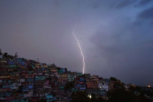 Lightning illuminates the skies of the Haitian capital Port-au-Prince during thunder storms on October 9, 2015