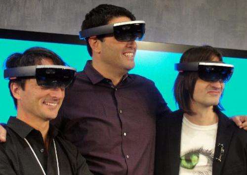 (L-R) Microsoft executives Joe Belfiore, Terry Myerson and Alex Kipman pose wearing HoloLens eyewear that overlays 3D images on 