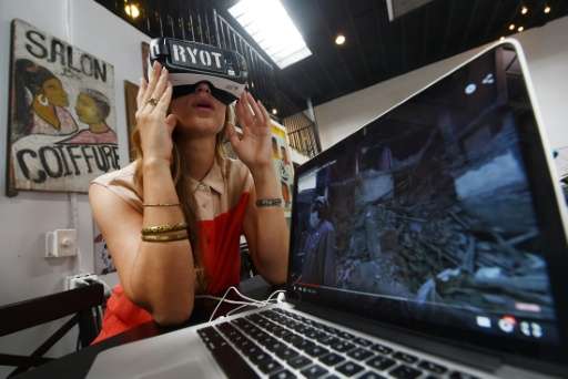 Molly Swenson, COO of RYOT, shows the virtual reality headset used to view their productions at their offices in Los Angeles, Ca
