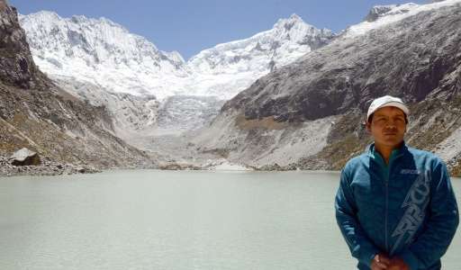 Mountan guide Saul Luciano Lliuya stands at a lagoon formed under the almost disappeared ice and snow mass on the Churup glacier