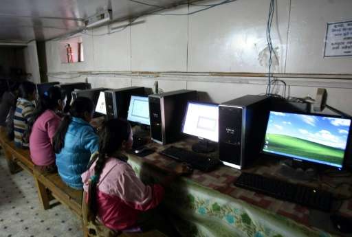 Nepalese girls surfing the internet in the village of Nagi, some 200 kms west of Kathmandu using home-made computers assembled i
