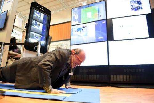 Paul Lukowicz, Scientific Director at the German Research Center for Artificial Intelligence displays a gymnastics mat during th